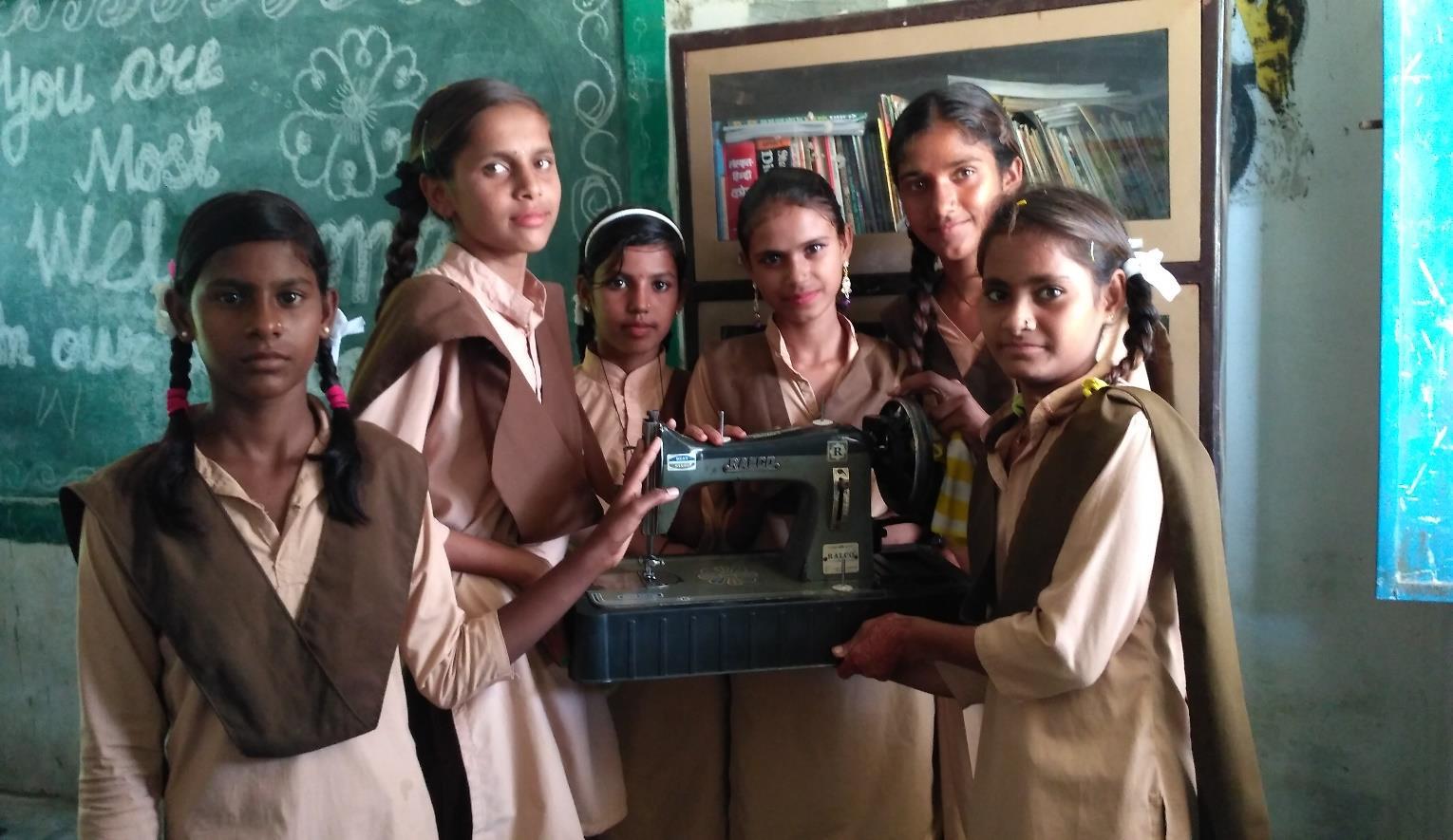 GGUPS Sallada School Students with the sewing machine that has transformed their community